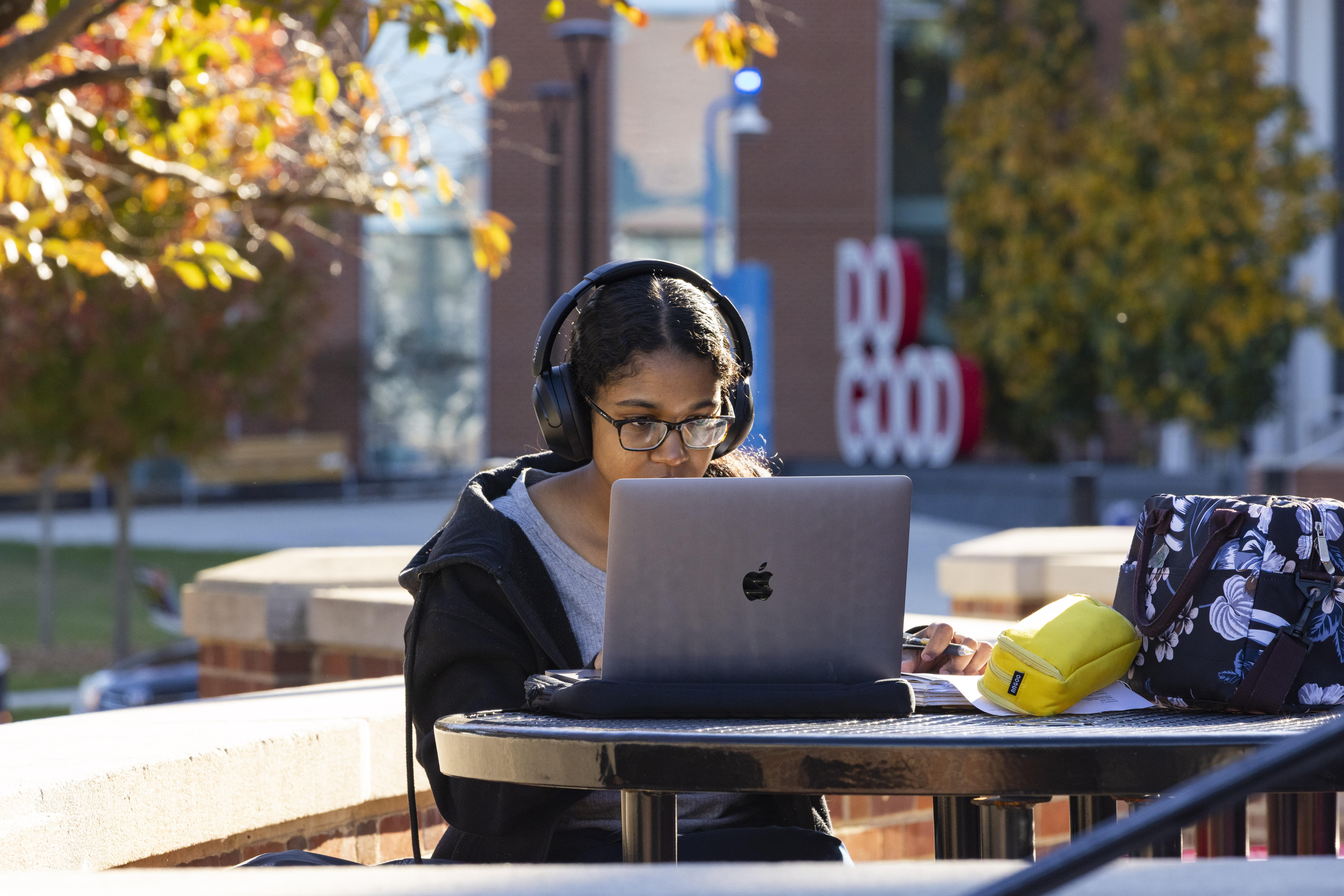 UMD Campus student using computer in front of the Do Good Institute